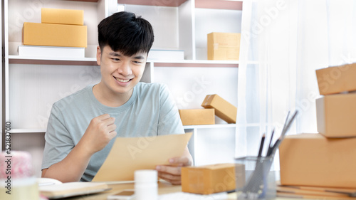 Man was happy after receiving an order from an internet customer, New business style for young people working at home and owning businesses, Online shopping SME entrepreneur, Packing box, Sell online.
