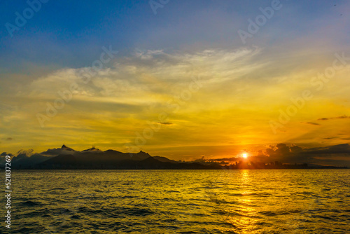 Sunset over the sea and the coast of Rio de Janeiro City, State of Rio de Janeiro, Brazil.