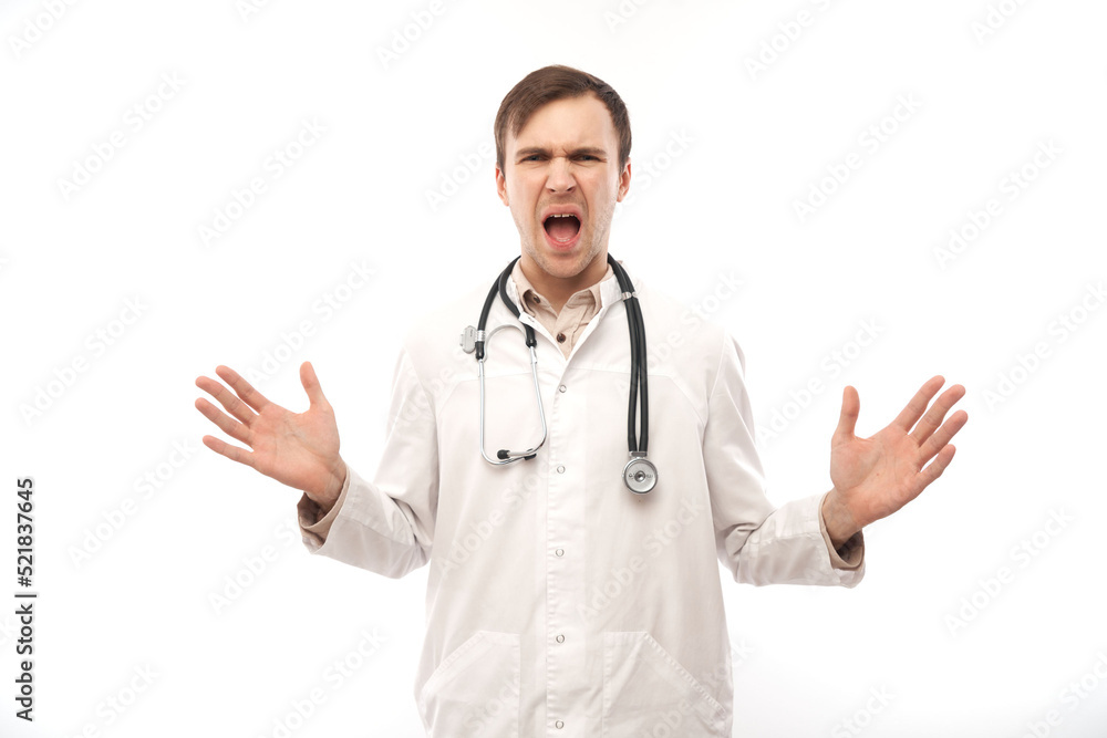 Portrait of angry doctor in white medical coat with stethoscope upset face screaming on white background with copy space Portrait of angry doctor in white medical coat with stethoscope upset face screaming on white background with copy space