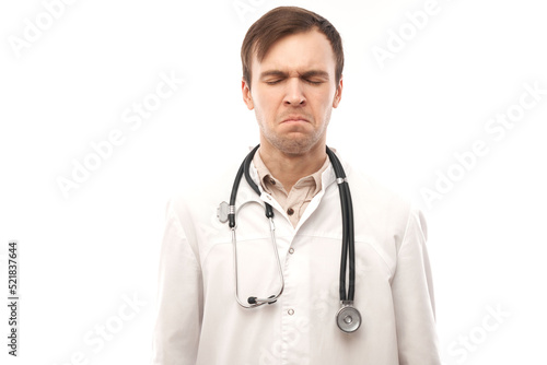 Portrait of angry doctor in white medical coat with stethoscope upset face screaming on white background with copy space
