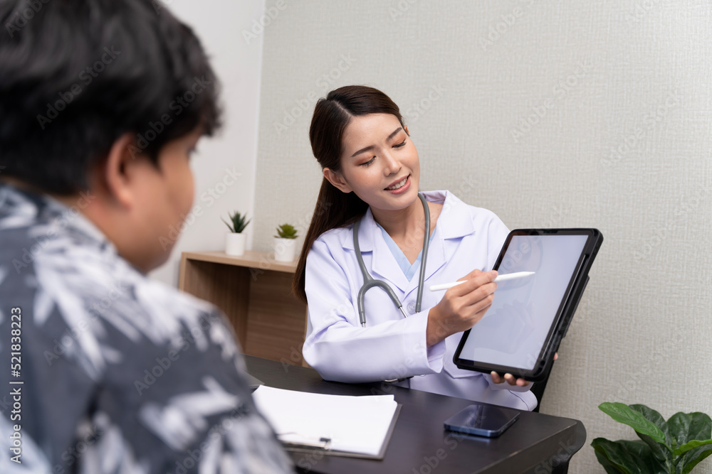 A beautiful Asian doctor discusses the condition of a male patient being hospitalized Check results in tablet A beautiful Asian doctor discusses the condition of a male patient being hospitalized Check results in tablet