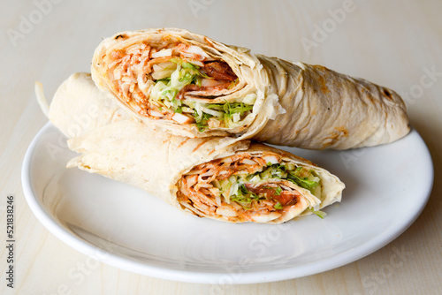 Lavash doner kebab ( zurna tavuk et doner durum )  or shawarma sliced in plate isolated.  photo