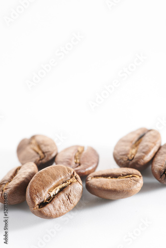 Roasted coffee beans isolated close up on white background, clipping path