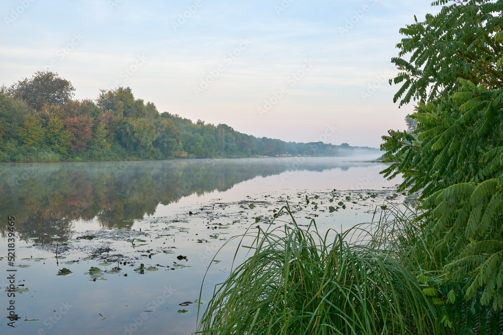Calm foggy view of the river in Ukraine at sunrise. Calm foggy view of the river in Ukraine at sunrise.