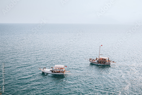 Fotografi Two excursion luxury ships or motorboats sails on the water surface of the Medit