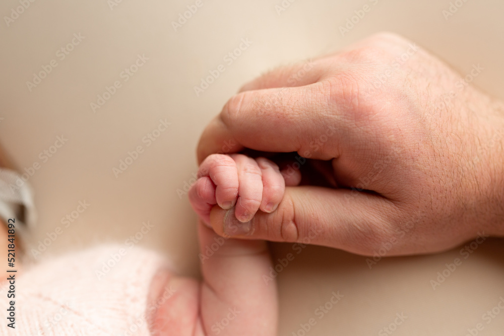 newborn baby holding father's finger. hand of a newborn baby newborn baby holding father's finger. hand of a newborn baby