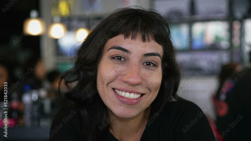 Portrait of a hispanic latin girl smiling at camera sitting at restaurant cafe Portrait of a hispanic latin girl smiling at camera sitting at restaurant cafe