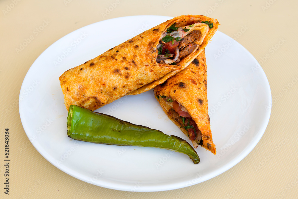 Lavash doner kebab ( zurna doner durum ) or shawarma sliced in plate