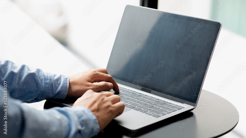 Businessman typing on a laptop keyboard, he is filling out his credit card information to pay for an order on an Internet shopping site. Online shopping and credit card payment concept. Businessman typing on a laptop keyboard, he is filling out his credit card information to pay for an order on an Internet shopping site. Online shopping and credit card payment concept.