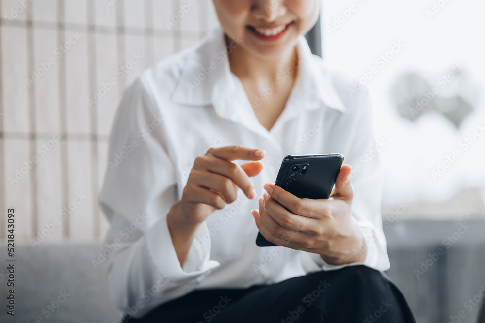 Asian woman using mobile phone, she surfs internet and social media on smartphone, chatting on app with friends. The concept of using technology in communication and the use of the Internet. Asian woman using mobile phone, she surfs internet and social media on smartphone, chatting on app with friends. The concept of using technology in communication and the use of the Internet.