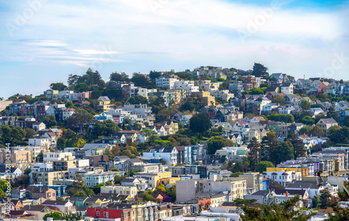 Rows of townhouses and apartment buildings on a sloped land in San Francisco, California © Jason