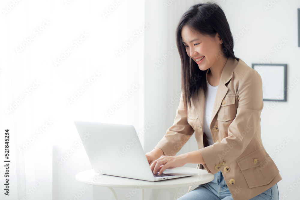 Young asian businesswoman working on laptop computer on desk at home office, freelance looking and typing on notebook on table, lifestyles of woman studying online, business and education concept. Young asian businesswoman working on laptop computer on desk at home office, freelance looking and typing on notebook on table, lifestyles of woman studying online, business and education concept.