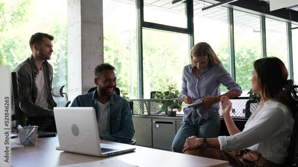 Group of millennial male and female creative occupation casual conversation meeting with cheerful and smiling,office friend standing discussion together in office Group of millennial male and female creative occupation casual conversation meeting with cheerful and smiling,office friend standing discussion together in office