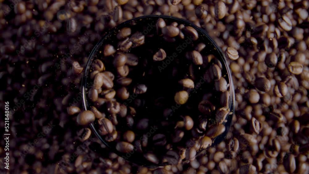 Process grinding coffee grains close up. Top view rotating fresh aromatic beans Process grinding coffee grains close up. Top view rotating fresh aromatic beans