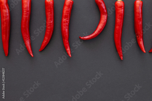 Red chili pepper on black background