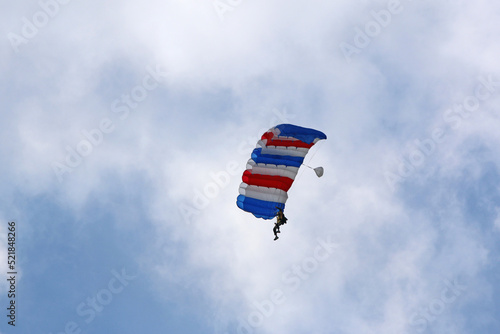 Skydiver flying wing in a blue sky 