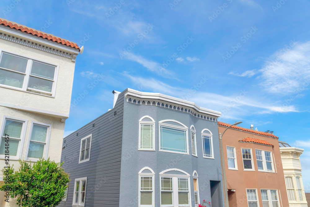 Suburban houses with pastel colors exterior in a low angle view in San Francisco, California