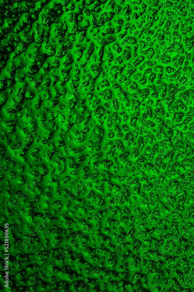 Bright green winter background. The surface of ice frozen on the window pane. An abstract pattern with a metallic sheen, like streams of mercury. Rich vivid vertical backdrop. Close-up Bright green winter background. The surface of ice frozen on the window pane. An abstract pattern with a metallic sheen, like streams of mercury. Rich vivid vertical backdrop. Close-up