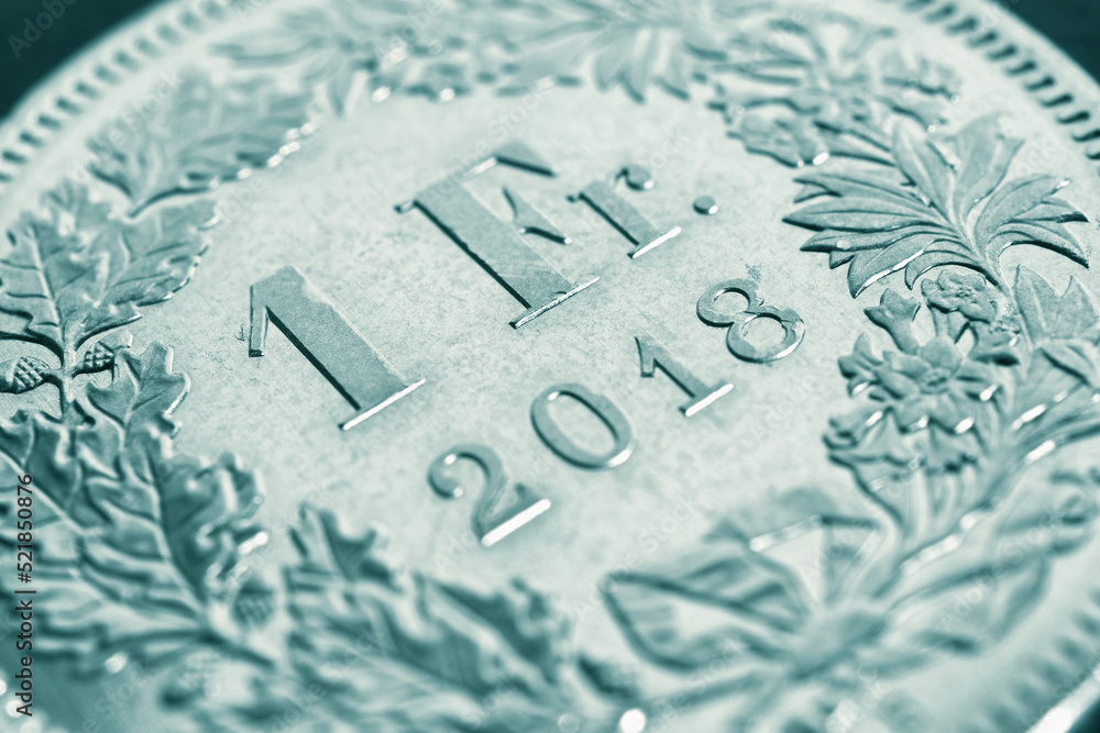 1 one Swiss Franc coin close up. Pale green tinted illustration about economy or banking. Business and taxes. Money and Central Bank of Switzerland. Macro 1 one Swiss Franc coin close up. Pale green tinted illustration about economy or banking. Business and taxes. Money and Central Bank of Switzerland. Macro