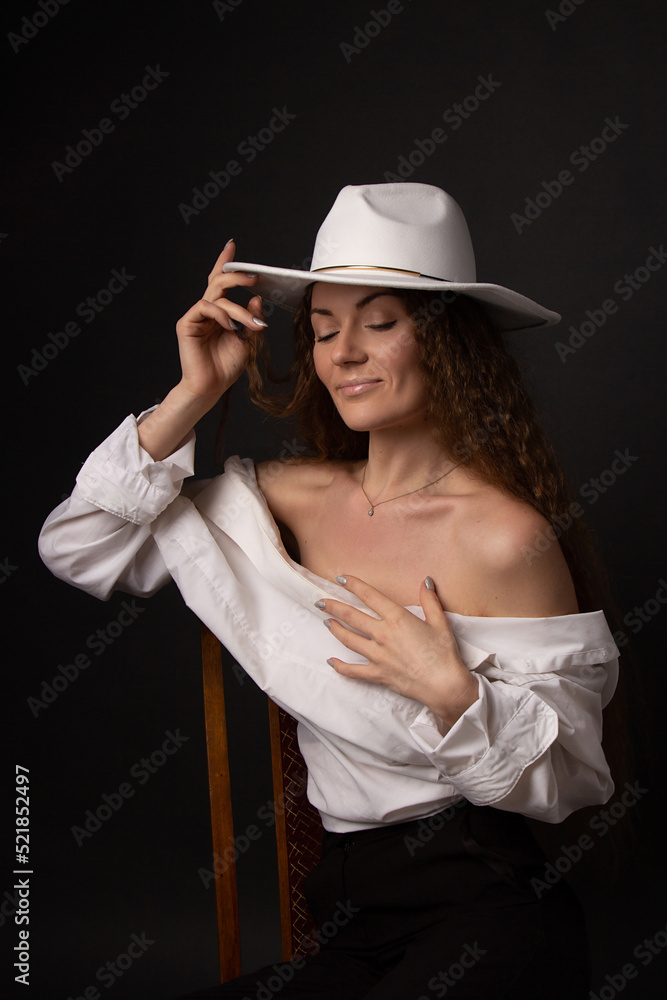 A beautiful girl in a white brim hat smiles smugly, studio portrait, fashion, self-confident A beautiful girl in a white brim hat smiles smugly, studio portrait, fashion, self-confident