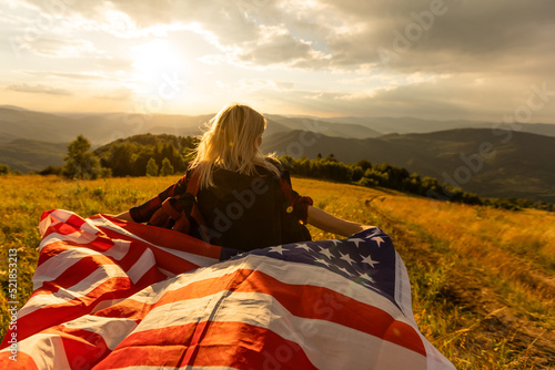 young beautiful woman holding USA flag.