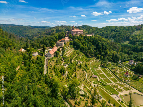 Aerial drone fly near the Pernstejn castle, Czech Republic. Vysocina region near the Nedvedice village. Summer day with sun and blue sky. Green nature and fresh forest. photo