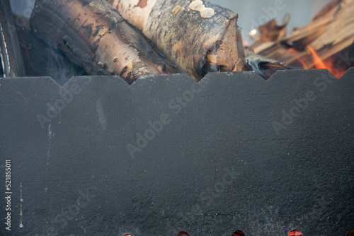 wood burn in a black grill 
