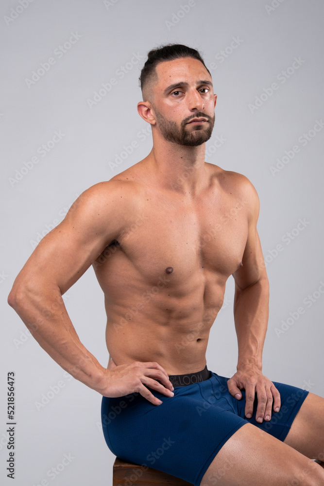 Shirtless, muscular male posing for the camera and flexing Shirtless, muscular male posing for the camera and flexing