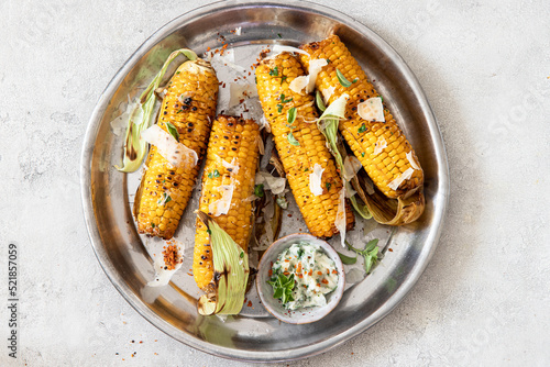 Roasted or grilled sweet corn cobs with garlic butter and  parmesan cheese  