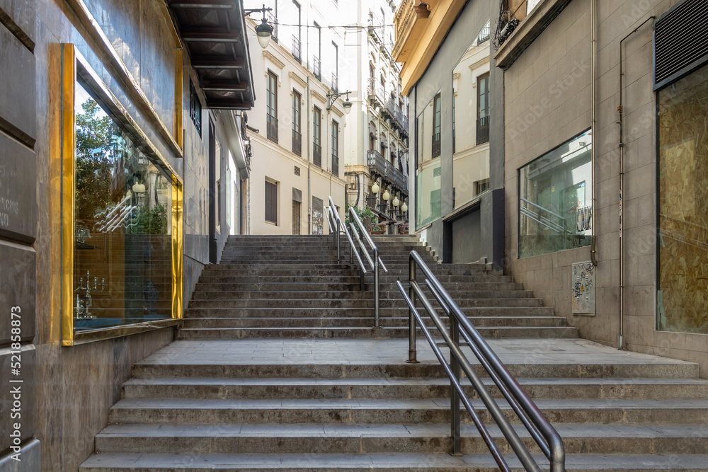 Fototapeta premium Stairway between the Angel Gaivet shopping street and the Plaza del Carmen or the town hall in the center of Granada (Spain) on a summer morning