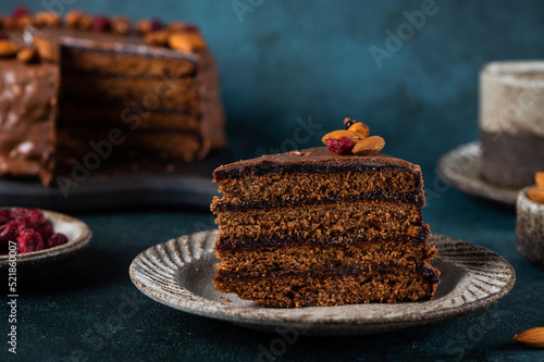Chocolate Austrian dessert Sacher with apricot jam and nuts. Traditional austrian dessert. Sacher cake. Chocolate cake with jam
