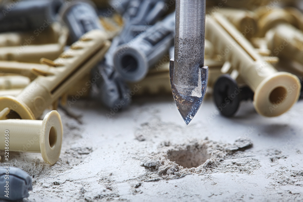 Ceramic drill bit make holes in concrete wall with industrial drill