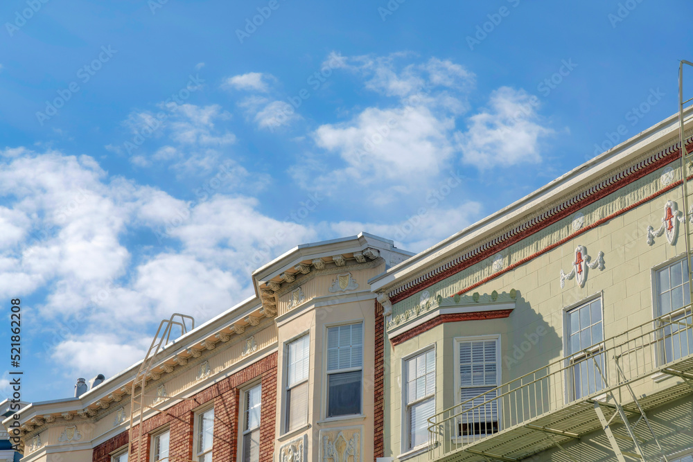 Slanted view of flat roofs of complex residential buildings with emergency staircase