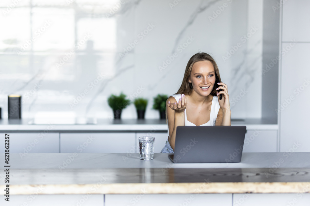 Busy young business woman talking on smart phone with clients, colleagues, working remotely on laptop in the morning. Female freelancer tutor student having phone conversation call Busy young business woman talking on smart phone with clients, colleagues, working remotely on laptop in the morning. Female freelancer tutor student having phone conversation call