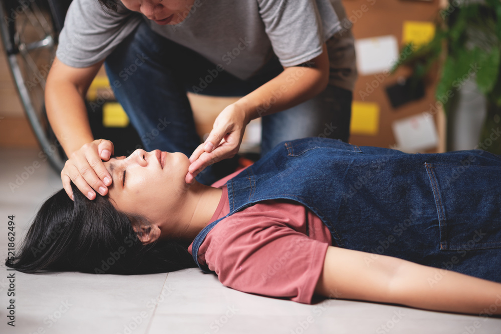 Emergency help on unconscious woman, Preparing first aids emergency CPR on heart attack woman in home, One part of the process resuscitation - healthcare and insurance concept. Emergency help on unconscious woman, Preparing first aids emergency CPR on heart attack woman in home, One part of the process resuscitation - healthcare and insurance concept.