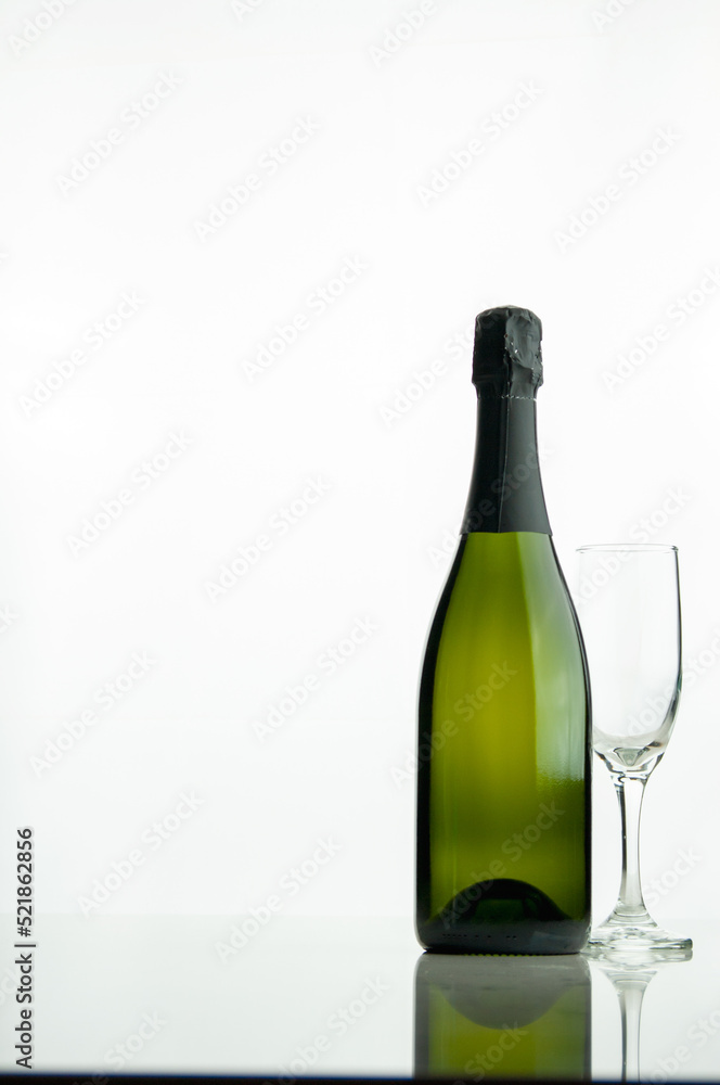 Bottle of champagne and a glass on a white background Bottle of champagne and a glass on a white background