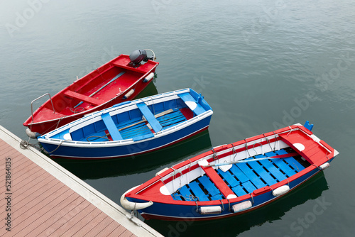 Colorful boats moored in fishing port. Top view, space for text.  © Alfredo López