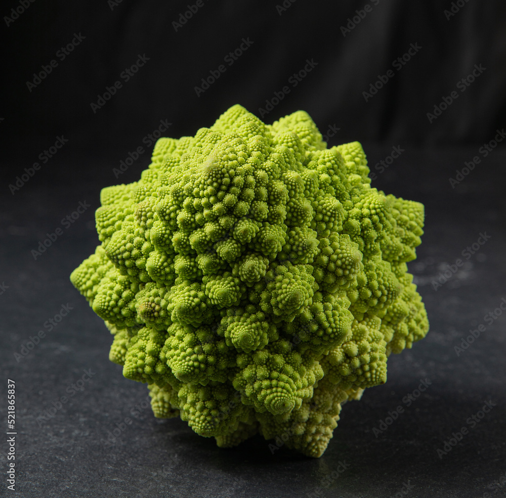 Romanesco broccoli head on a dark stone surface, cabbage, close up, fibonacci sequence, for those who love mathematics Romanesco broccoli head on a dark stone surface, cabbage, close up, fibonacci sequence, for those who love mathematics