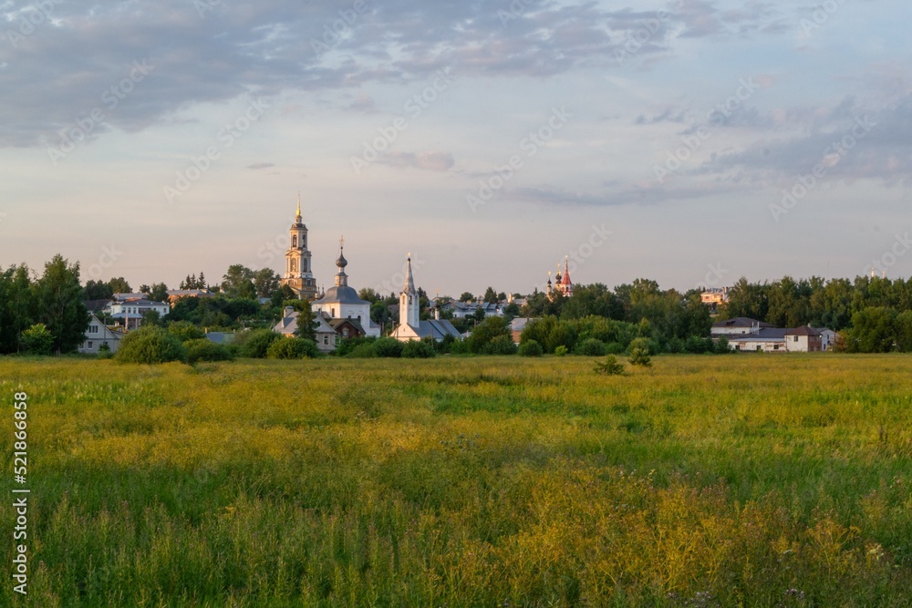 Fototapeta premium summer panoramic photo of the city of Suzdal with churches at sunset летнее панорамное фото город Суздаль