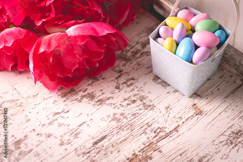 Pastel and hazy jordan almonds and flower on a wooden tray for M