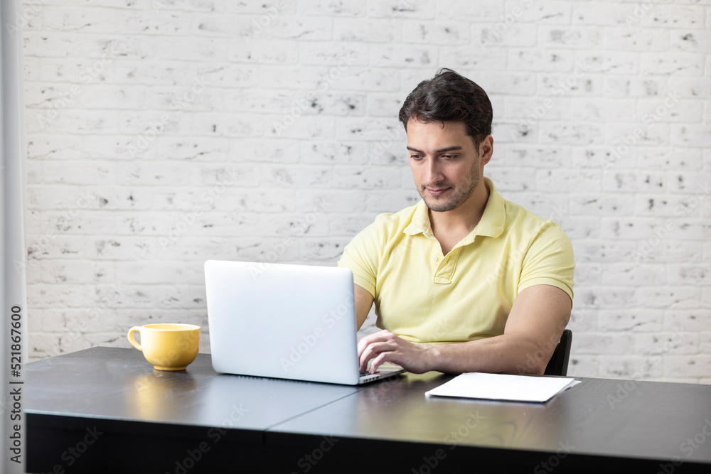 Serious businessman sitting at the table at home and working. Distant work concept Serious businessman sitting at the table at home and working. Distant work concept