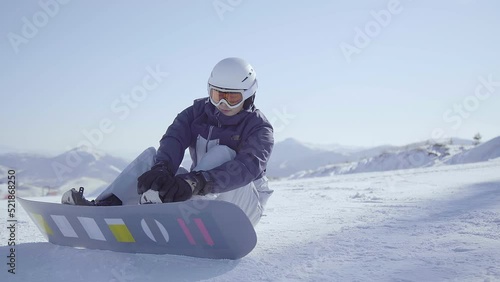 Young man with snowboard on the snow,4K photo