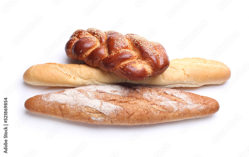 Assortment of baked bread on white background.
