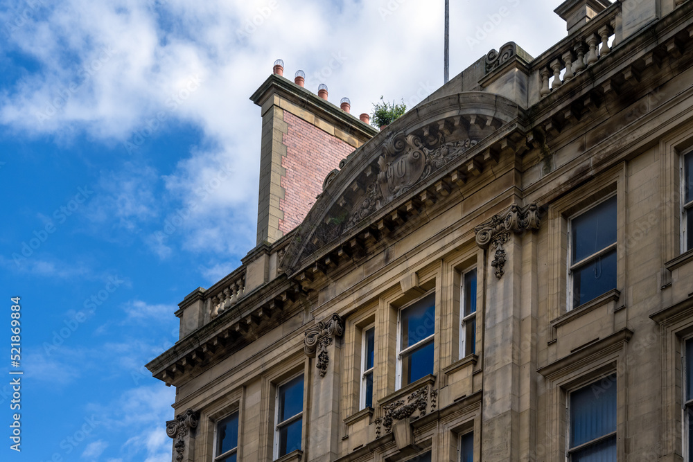 Detail of the facade of an art Nouveau stone building, with typical organic forms