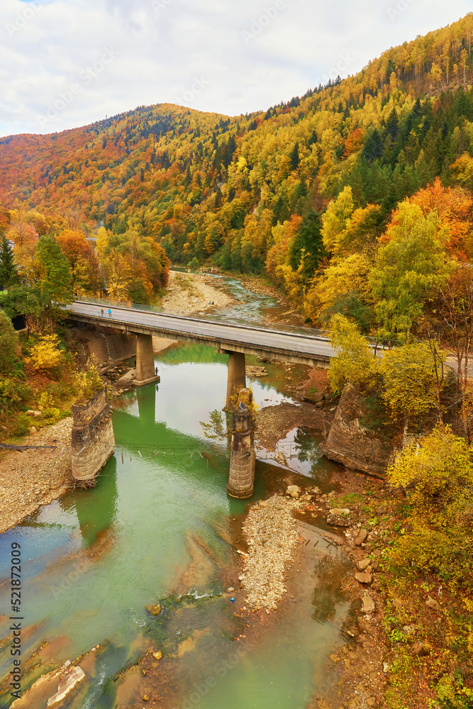View on railway bridge above the Prut river. Beauteful autumn in Carpathian mountains, Ukraine