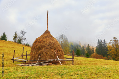 Autumn landscape, haystacks on the pasture, view of mountains. photo