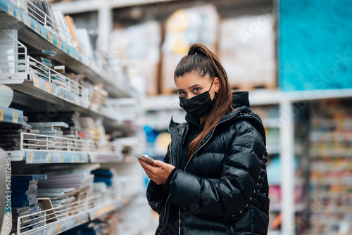 Woman with face mask buying during virus pandemic.