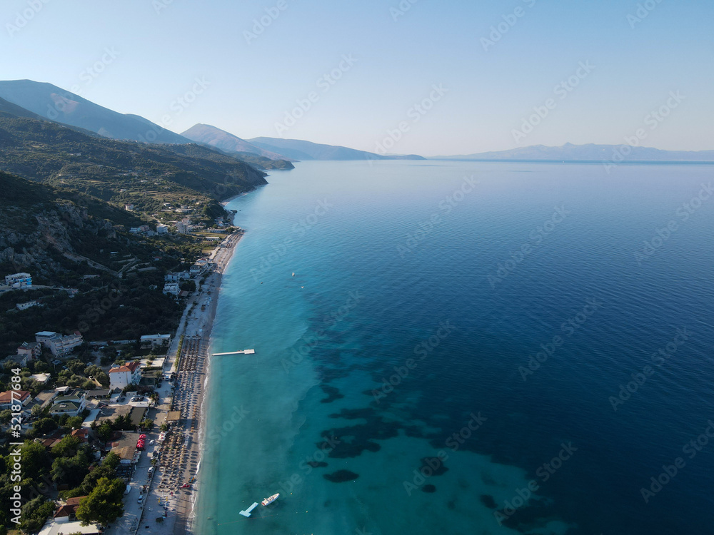 Obraz premium Drone photo of the summer beach resort with umbrellas at the Ionian Sea coast in Albania, Borsch