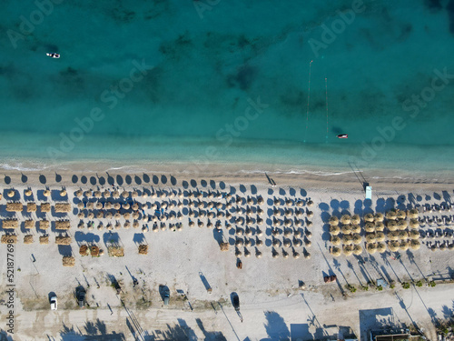 Drone photo of the summer beach resort with umbrellas at the Ionian Sea coast in Albania, Borsch