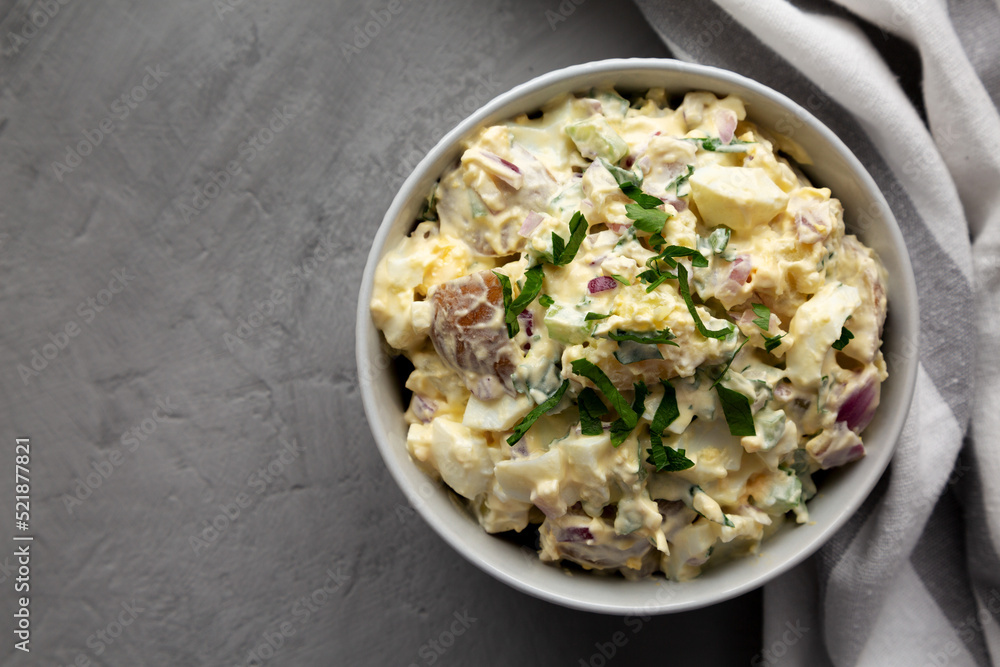 Homemade Healthy Potato Salad with Eggs in a Bowl on a gray surface, top view. Flat lay, overhead, from above. Space for text. Homemade Healthy Potato Salad with Eggs in a Bowl on a gray surface, top view. Flat lay, overhead, from above. Space for text.